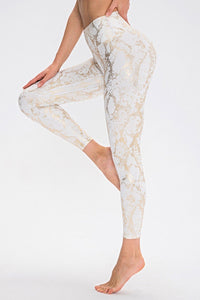 Animal print slim fit long sports pants with wide waistband from Trendsi, showing detail of the patterned fabric and athletic style.