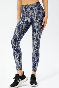 Animal print slim fit sports pants with wide waistband, long style, by Trendsi, featuring bold animal pattern and comfortable athletic wear