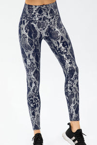 Animal print slim fit sports pants with wide waistband, designed for comfort and style in activewear.