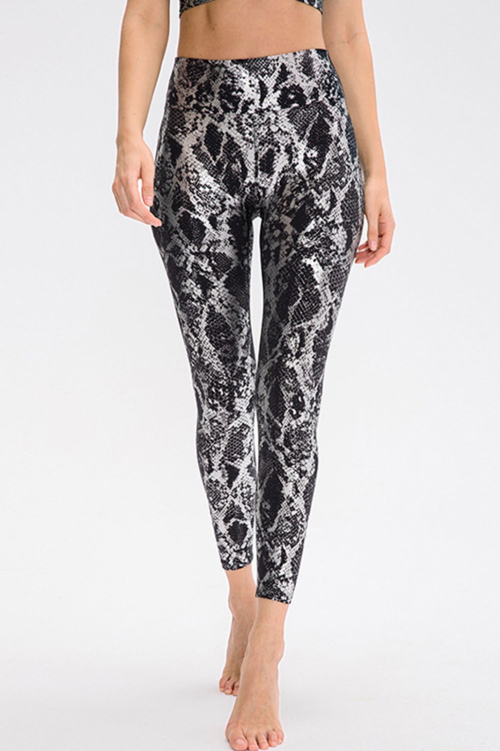 Animal print slim fit sports pants with wide waistband, designed for activewear and casual wear by Trendsi.
