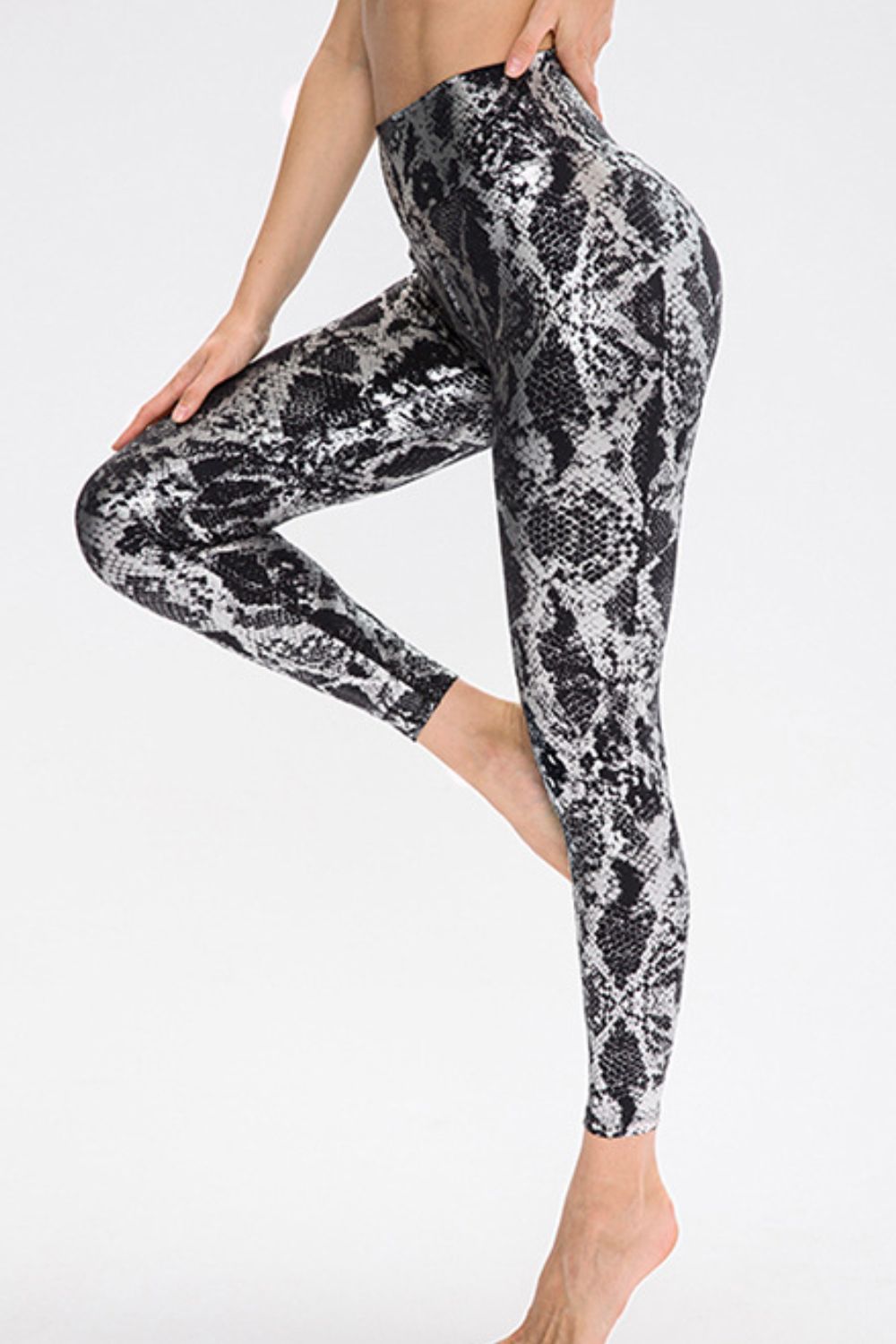 Animal print slim fit sports pants with wide waistband, long length, designed for activewear by Trendsi.