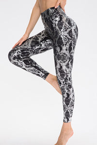 Animal print slim fit sports pants with wide waistband, long length, designed for activewear by Trendsi.