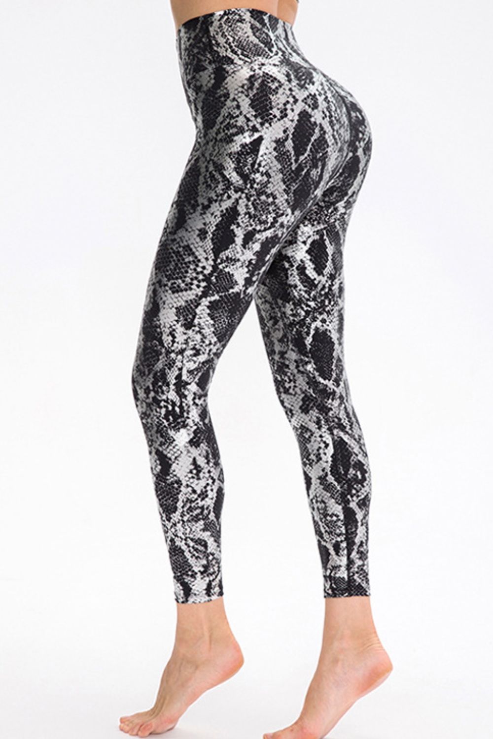 Animal print slim fit long sports pants with wide waistband from Trendsi, designed for comfort and style during workouts.