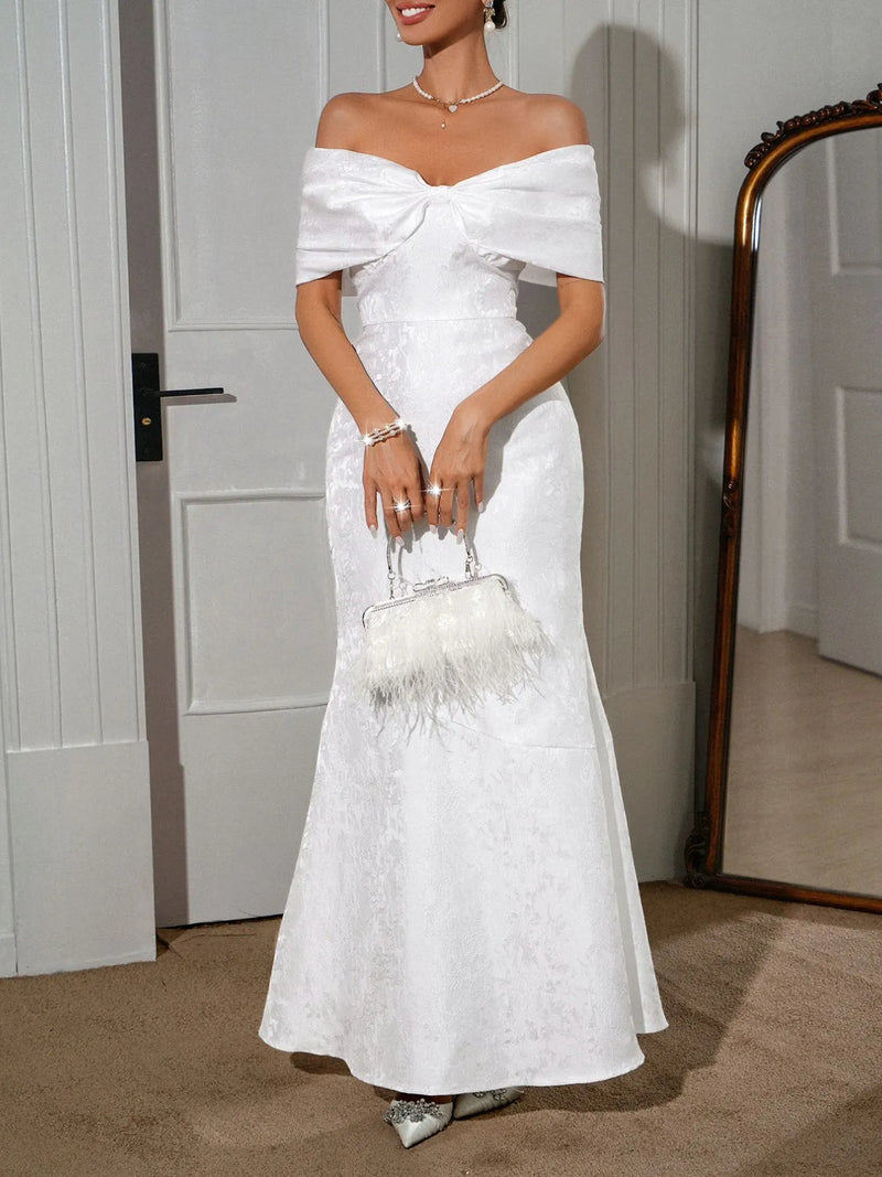 Off-shoulder maxi dress by Trendsi featuring a flowing silhouette, lightweight fabric, and a stylish bow detail at the shoulder.