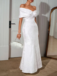 Off-shoulder maxi dress by Trendsi featuring a flowing silhouette, lightweight fabric, and elegant design with a fitted bodice.