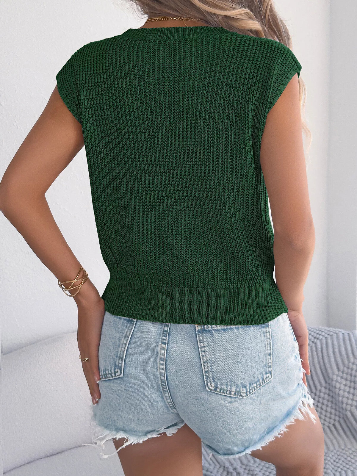 White cable knit cap sleeve sweater by Trendsi, featuring a cozy, textured knit design and a stylish cap sleeve fit.