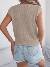 White cable knit cap sleeve sweater by Trendsi, featuring a cozy knit texture and stylish cap sleeves for casual wear.