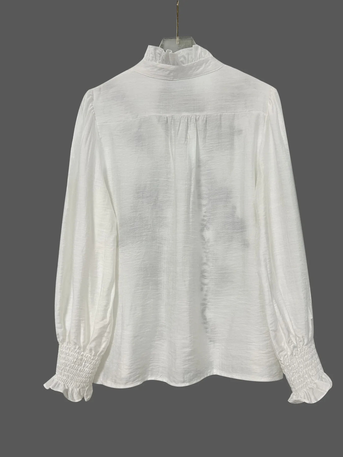 Embroidered long sleeve blouse from Trendsi featuring intricate embroidery, lightweight fabric, and a relaxed fit.