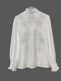 Embroidered long sleeve blouse from Trendsi featuring intricate embroidery, lightweight fabric, and a relaxed fit.