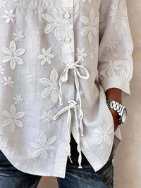 Plus size floral embroidered button-down shirt by Trendsi, featuring a white full-size design with colorful floral embroidery.