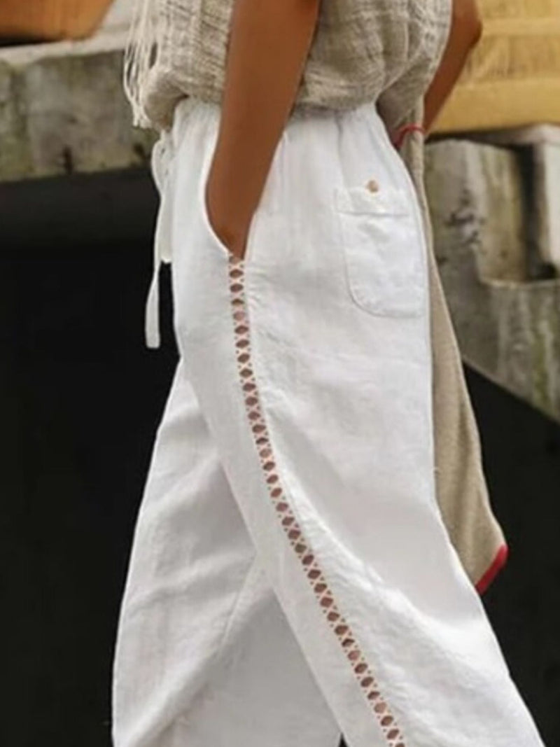 Hollow out trim cropped pants by Trendsi featuring a stylish cut-out design and tailored fit, shown on a model.