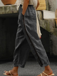 Hollow out trim cropped pants from Trendsi featuring stylish cut-out details and a modern, fitted design.