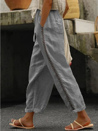 Hollow out trim cropped pants in black from Trendsi, featuring a stylish cut-out design and high-waisted fit.
