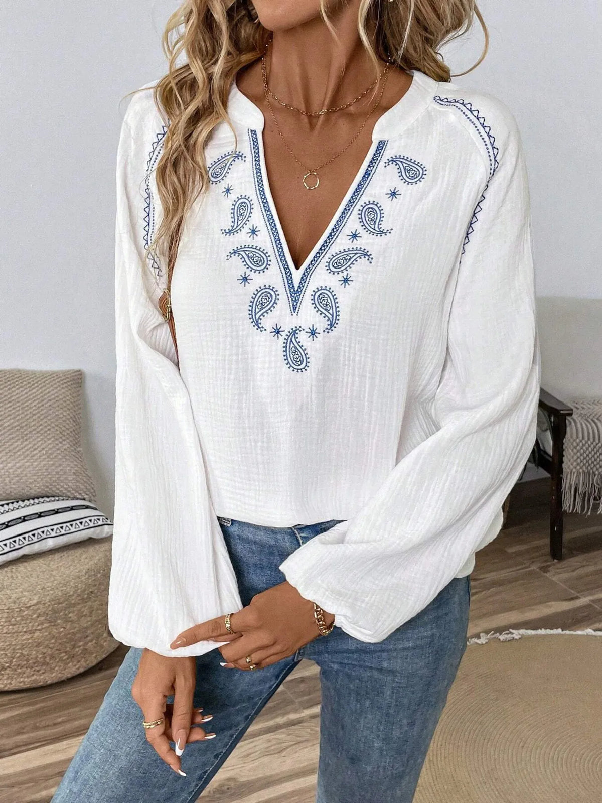 Paisley pattern notched long sleeve blouse by Trendsi, featuring a stylish design and classic collar, shown on a model.