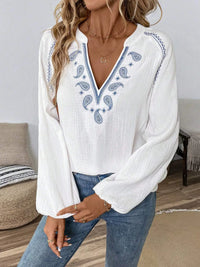 Paisley pattern notched long sleeve blouse by Trendsi, featuring a stylish design and classic collar, shown on a model.