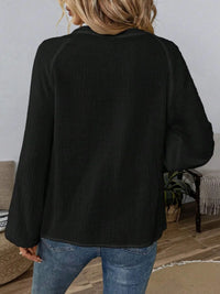 Paisley pattern notched long sleeve blouse from Trendsi featuring a stylish design and feminine fit, displayed on a hanger.