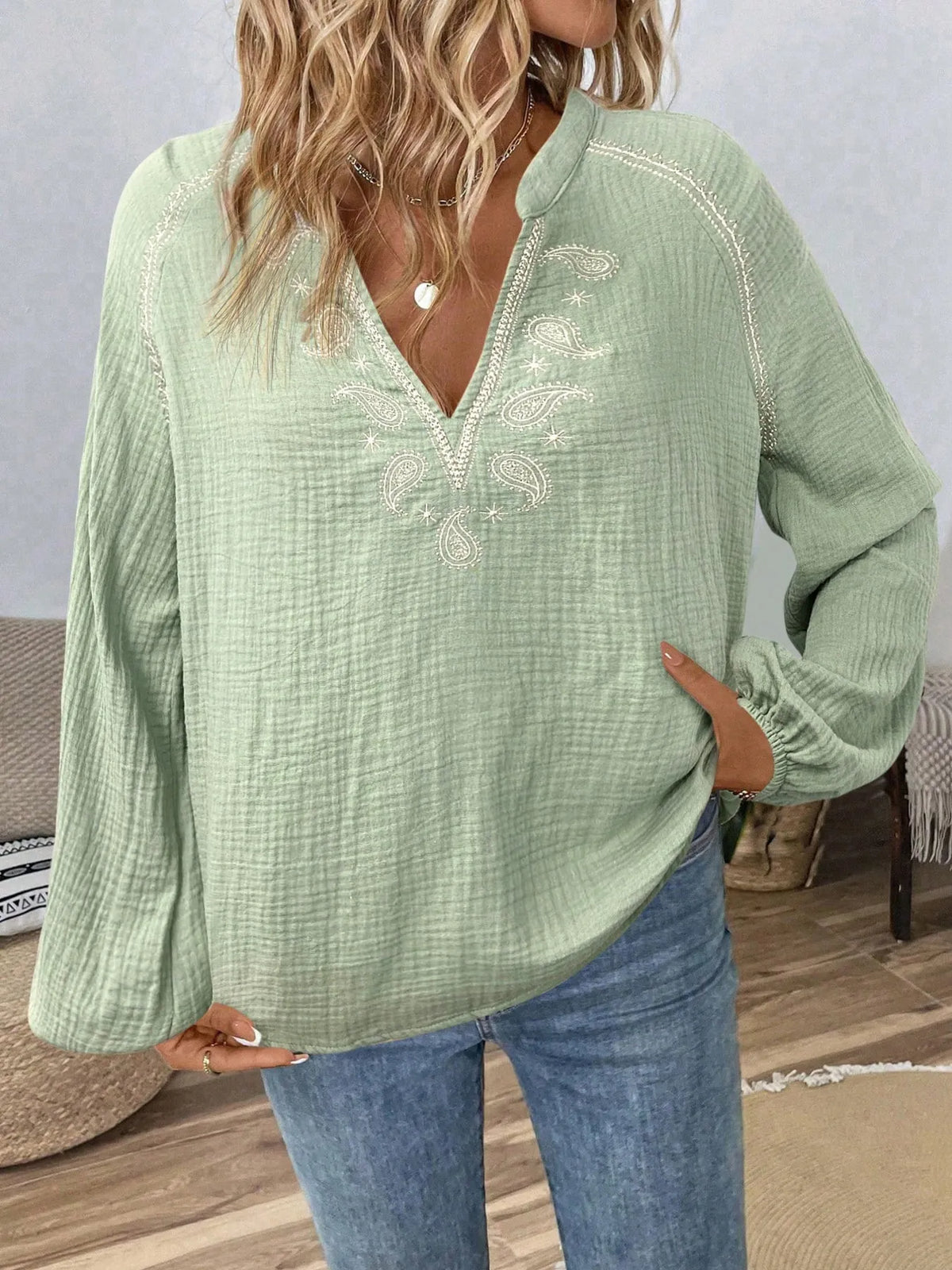 Long sleeve blouse with paisley pattern and notched neckline from Trendsi, featuring a stylish, flowing design.