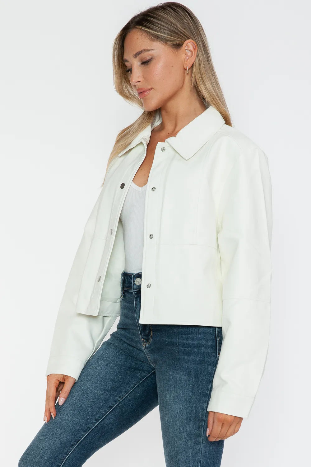 White Snobbish Snap Down Long Sleeve PU Leather Jacket by Trendsi, featuring a sleek design and snap button details.