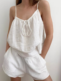 Relaxed fit tie front cami and shorts set by Trendsi, featuring a stylish, comfortable matching top and shorts for casual wear.