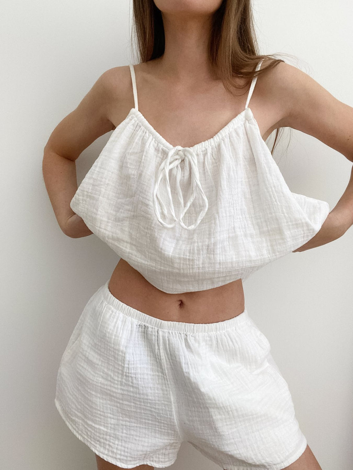 Tie front relaxed fit cami top and matching shorts set by Trendsi, featuring a casual, comfortable style with a tie detail at the front.