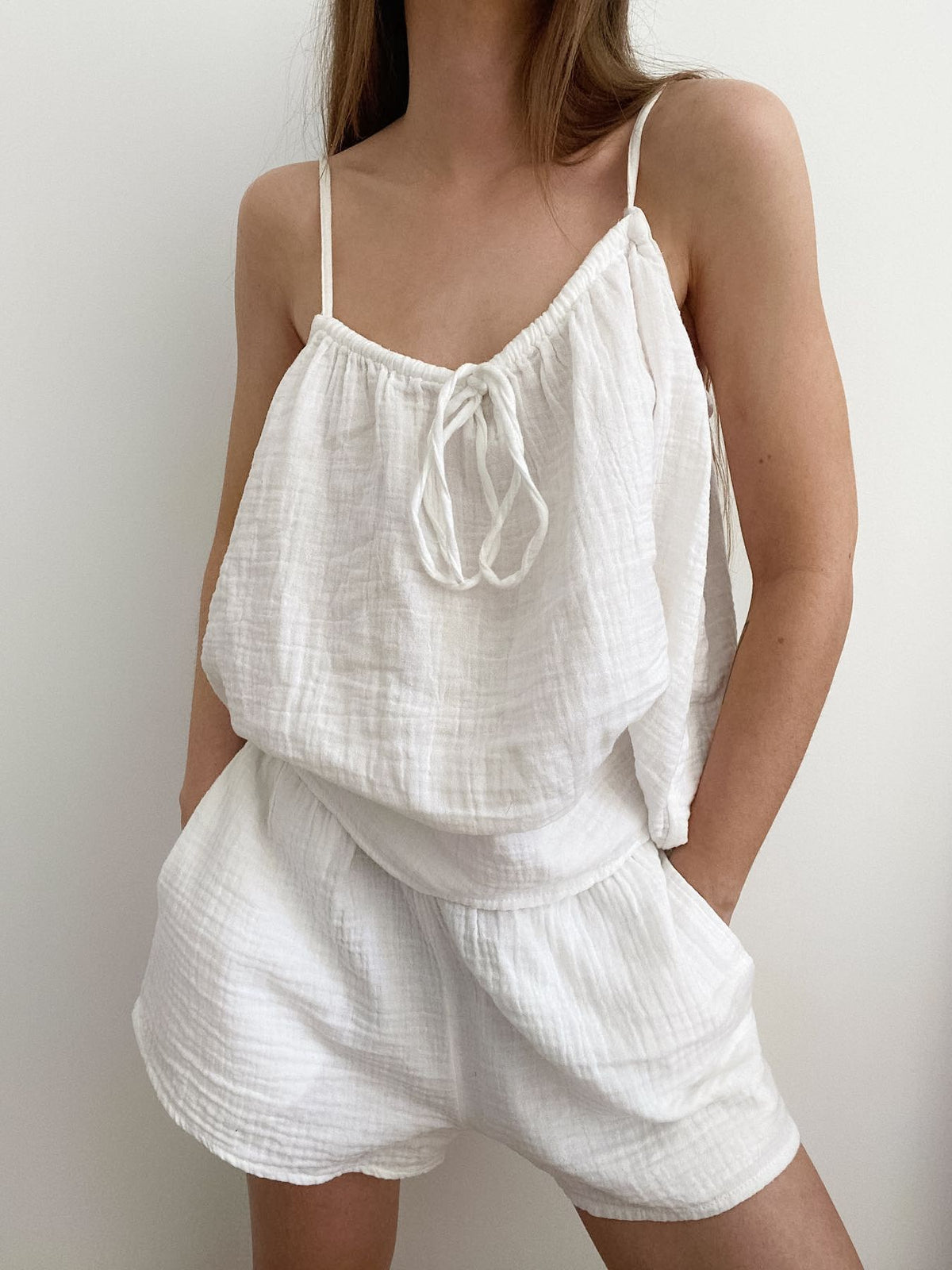 Trendsi tie front relaxed fit cami and shorts set, featuring a sleeveless top with tie detail and matching casual shorts.