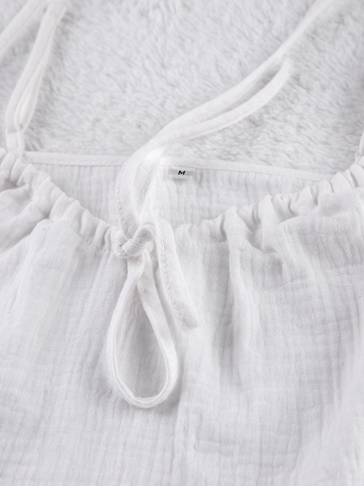 Relaxed fit tie-front cami and shorts set by Trendsi, featuring a stylish and comfortable matching top and shorts ensemble.