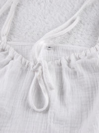 Relaxed fit tie-front cami and shorts set by Trendsi, featuring a stylish and comfortable matching top and shorts ensemble.