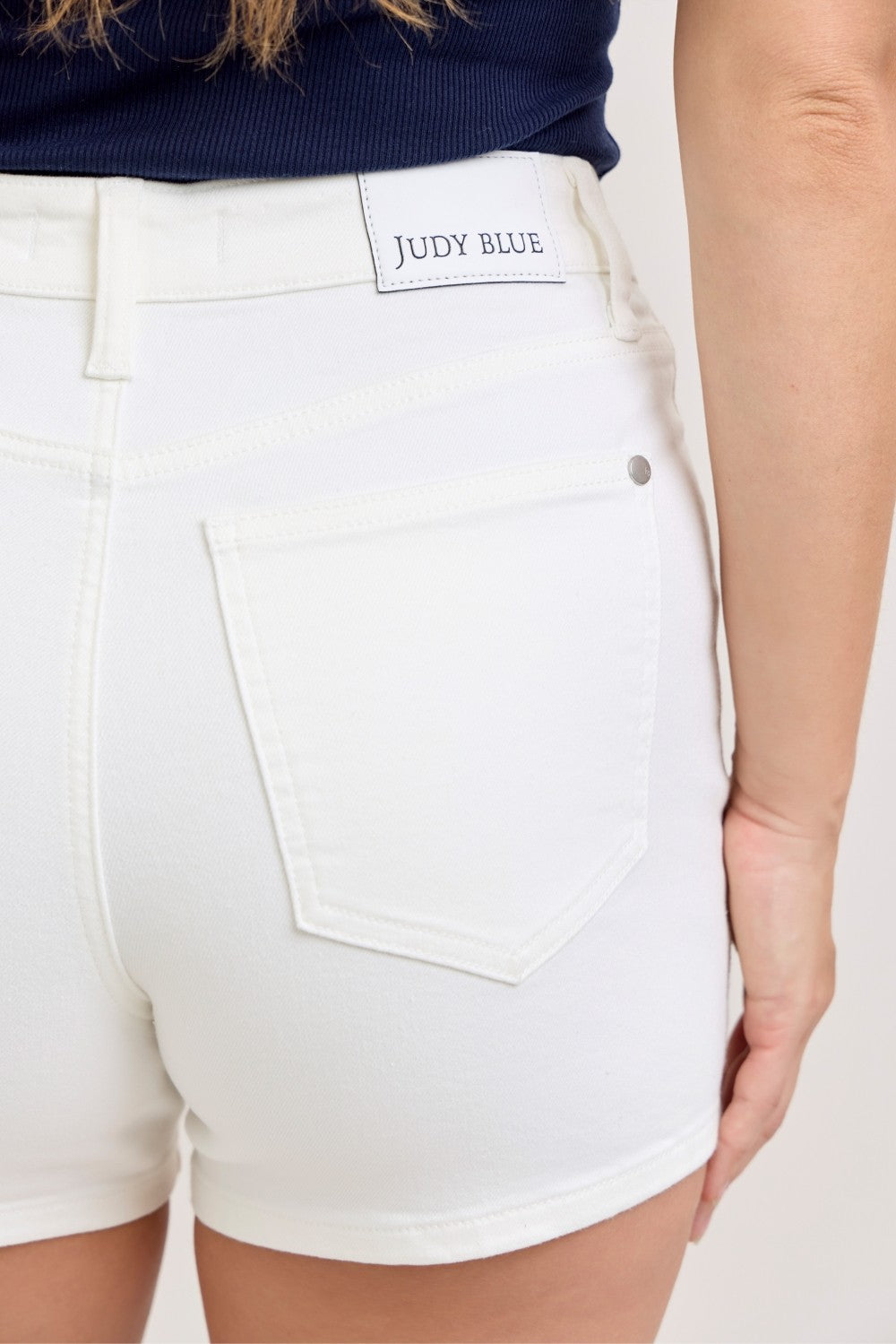 Plus size Judy Blue high-waisted slim shorts in white, featuring a full size fit and stylish design.