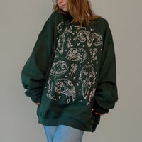 VesperTwine Bones Sweater in Juniper color, featuring a cozy knit design and ribbed cuffs, perfect for casual wear.