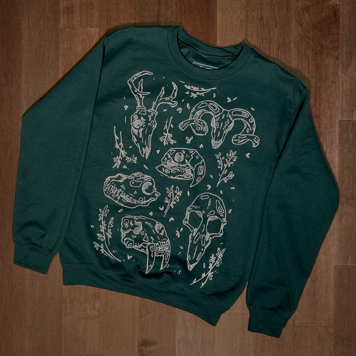 VesperTwine Bones Sweater in Juniper color, showing a cozy knit with bone pattern, long sleeves, and ribbed cuffs.