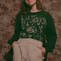 VesperTwine Bones Sweater in Juniper with bone pattern, cozy knit fabric, and ribbed cuffs and hem.