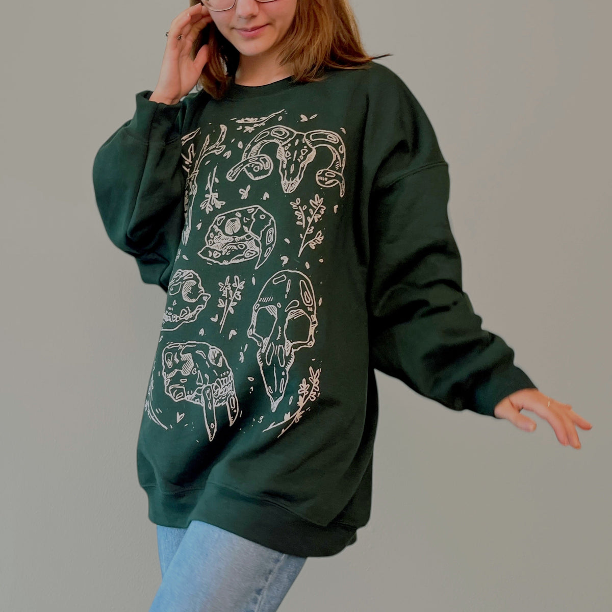 VesperTwine Bones Sweater in juniper color, cozy knit with bone pattern, long sleeves, and ribbed cuffs and hem.