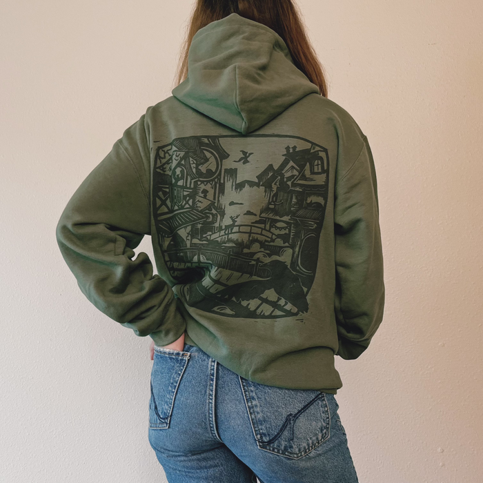 Olive green VesperTwine Home to the Unknown hoodie with front pocket and hood, casual style, visible fabric texture.