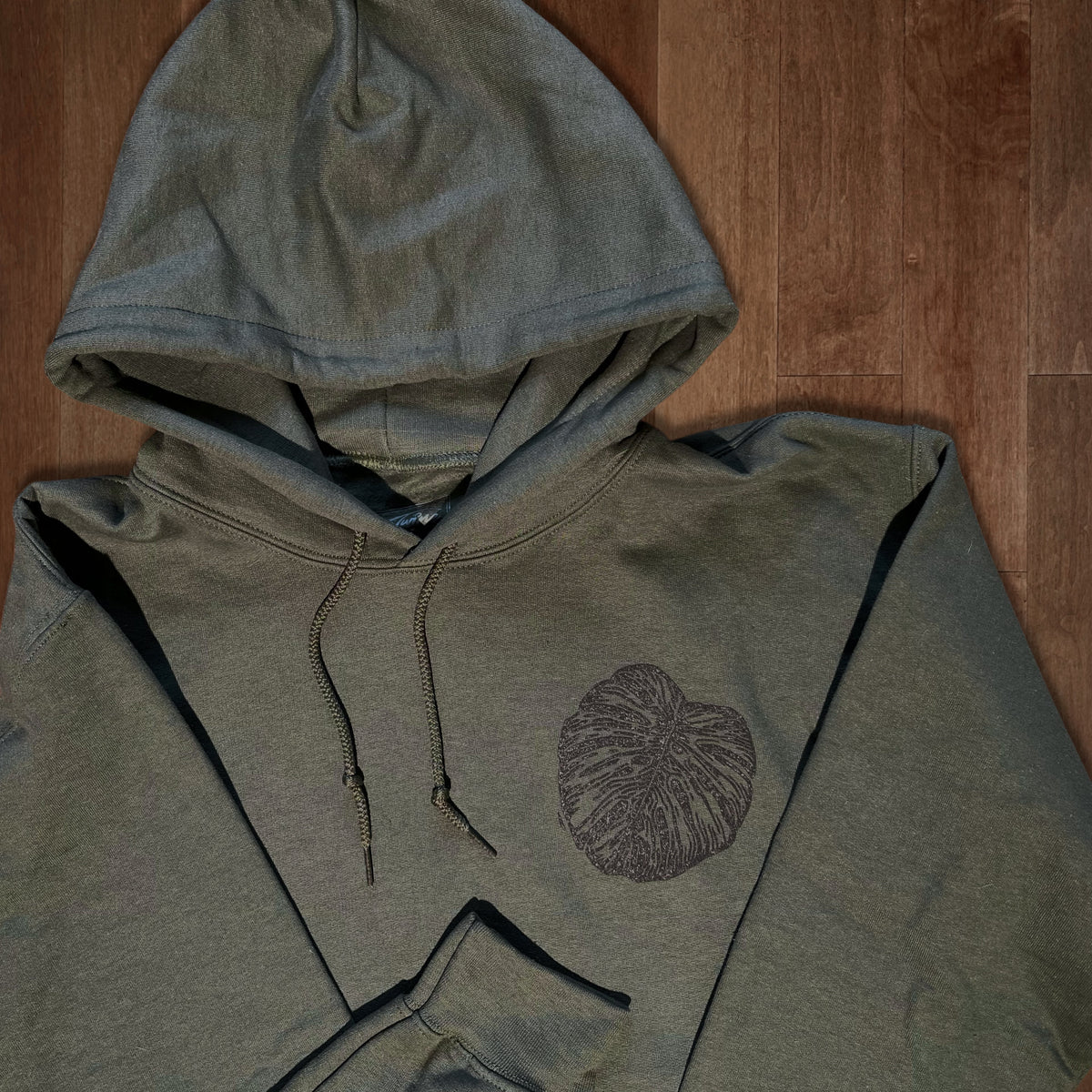 Olive green Monstera hoodie by VesperTwine featuring a Monstera leaf design on soft fabric.