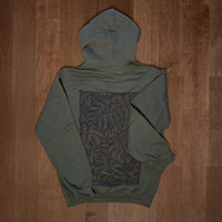 Olive green Monstera hoodie by VesperTwine featuring a large tropical leaf print on the front.