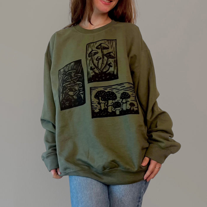Olive green Mushroom Sweater by VesperTwine featuring a cozy knit design and a relaxed fit on a mannequin.