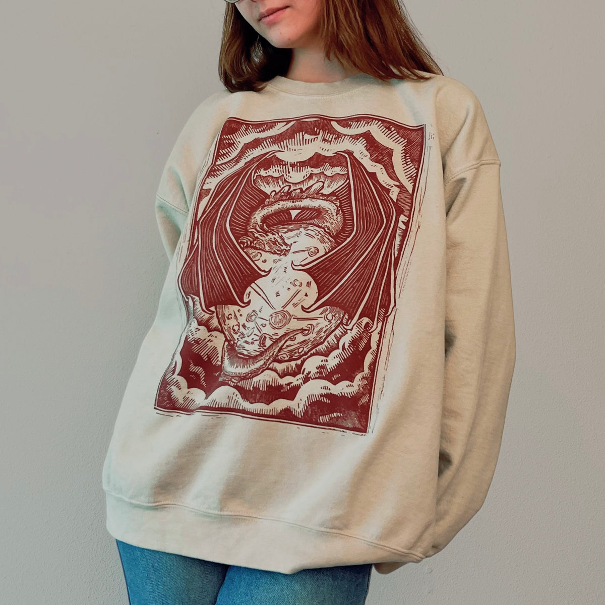 Light beige VesperTwine Dragon's Moon sweater on a small-sized mannequin, featuring a dragon and moon design.