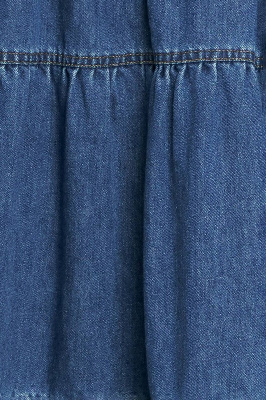 Washed denim midi dress by voglio.us featuring a casual fit, sleeveless design, and front pockets, styled with a relaxed look.