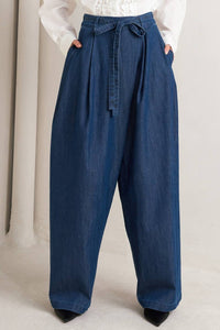 Pair of voglio.us crossover waist washed denim jeans with distressed details and a relaxed fit.