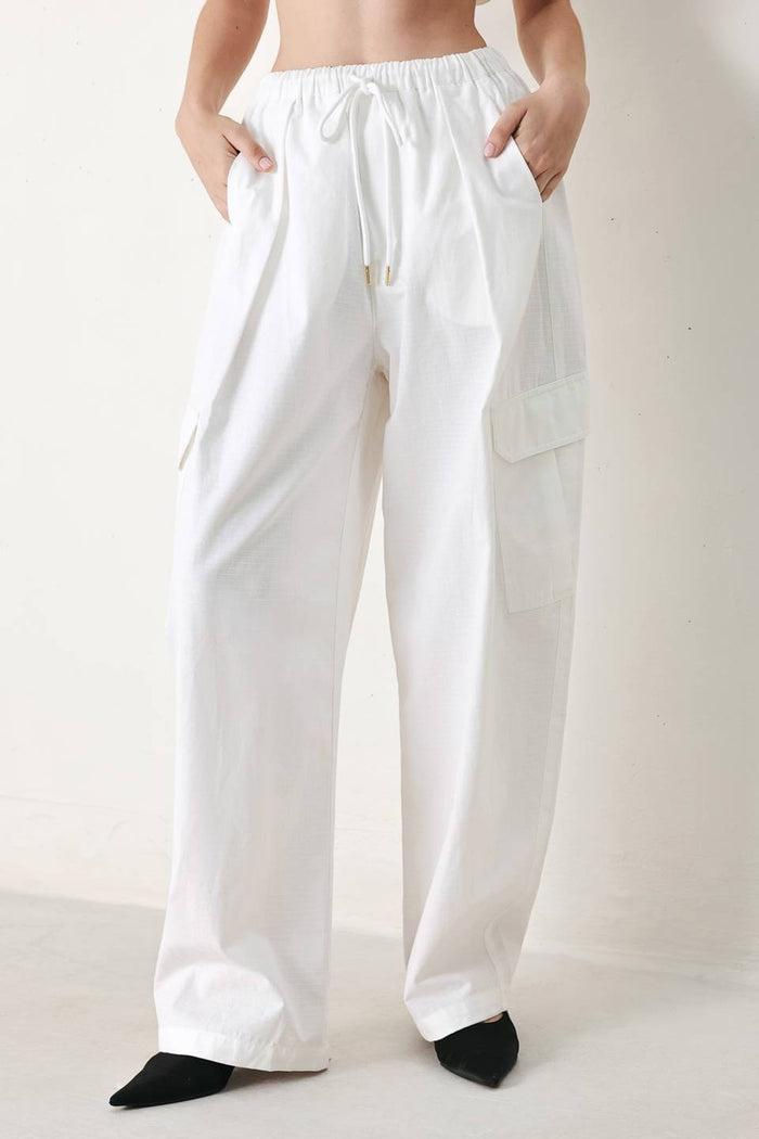Cotton balloon cargo pants by voglio.us featuring relaxed fit, multiple pockets, and elastic cuffs in a neutral color.