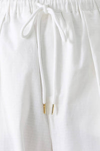 Light beige cotton balloon cargo pants with large side pockets and relaxed fit, by voglio.us.