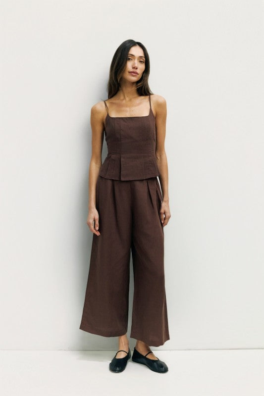 Light beige Jocelyn linen blend wide-leg pants from voglio.us displayed on a hanger, showing relaxed fit and flowing fabric.