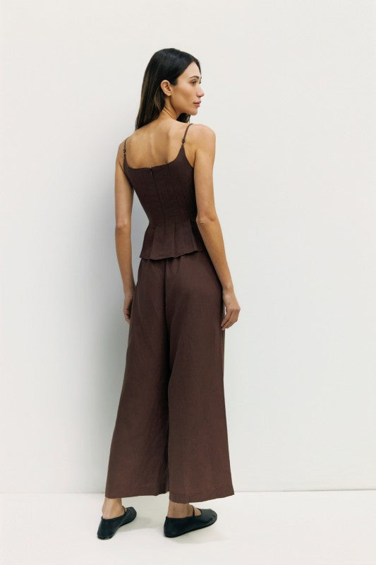 Light beige Jocelyn Linen Blend Wide-Leg Pants from voglio.us displayed on a hanger, showcasing their flowy wide-leg design.