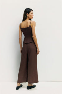 Light beige Jocelyn Linen Blend Wide-Leg Pants from voglio.us displayed on a hanger, showcasing their flowy wide-leg design.