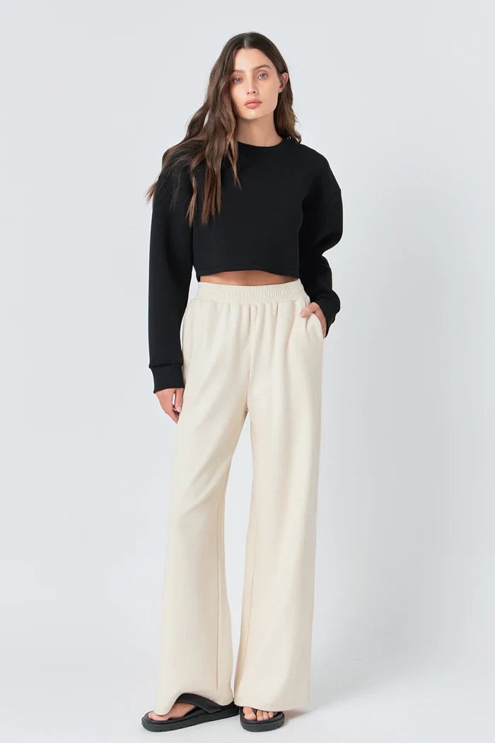 Wide knit pants by voglio.us featuring a relaxed fit, soft fabric, and stylish design, shown on a model in a casual setting.