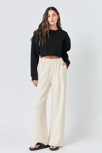 Wide knit pants by voglio.us featuring a relaxed fit, soft fabric, and stylish design, shown on a model in a casual setting.