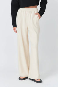 Wide knit pants by voglio.us in soft beige, featuring a relaxed fit and textured knit fabric, shown on a model.