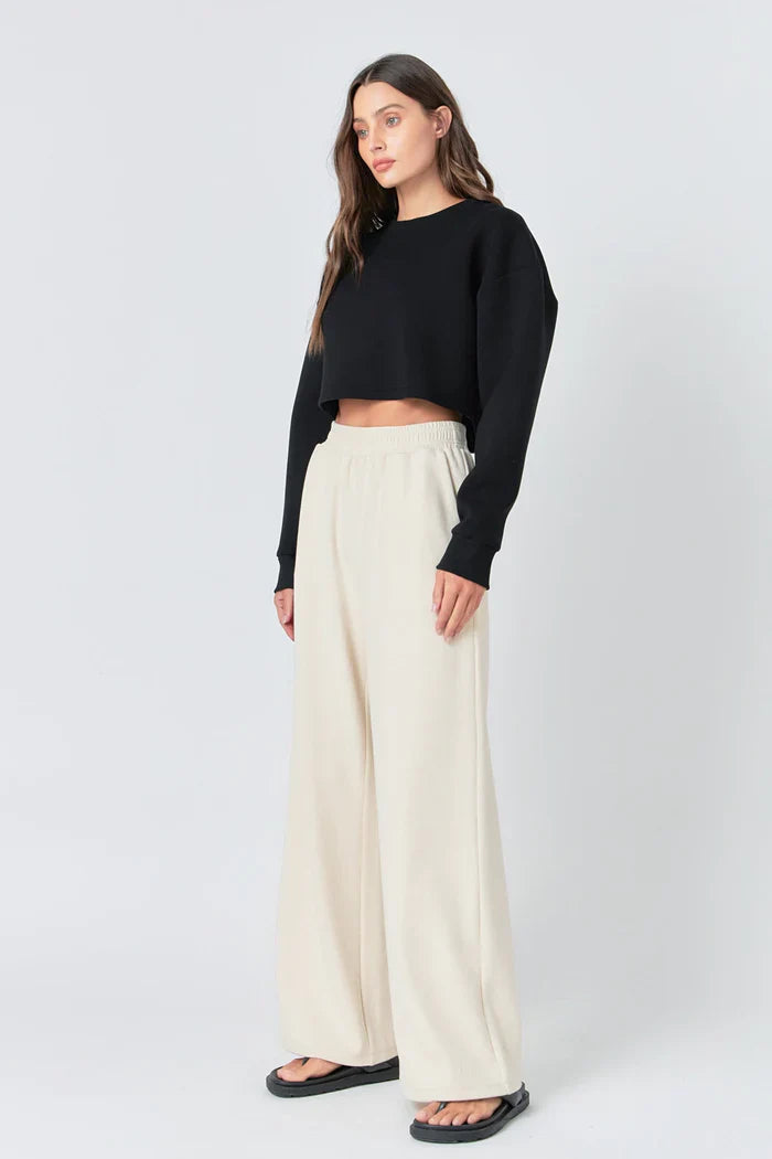 Wide knit pants from voglio.us featuring a relaxed fit and textured fabric, shown in a neutral color with a comfortable waistband.