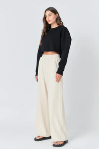 Wide knit pants from voglio.us featuring a relaxed fit and textured fabric, shown in a neutral color with a comfortable waistband.