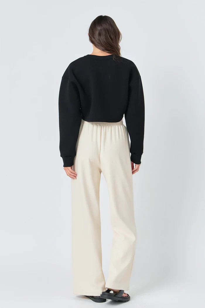 Wide knit pants by voglio.us featuring a soft, textured fabric and a relaxed fit, shown in a neutral color.